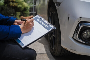 businessman in suit and car auto insurance agent assess car damage, discussing deductible, claims,...