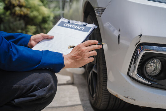 businessman in suit and car auto insurance agent assess car damage, discussing deductible, claims, coverage options comprehensive and collision insurance, completing necessary forms and appraisals.