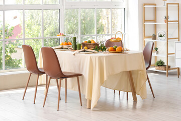 Beautiful table setting with citrus fruits and candles at home