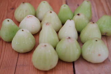 A water guava resting on wooden table