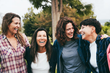 Group women friends hugging each other at park city Happy friends having fun smiling together