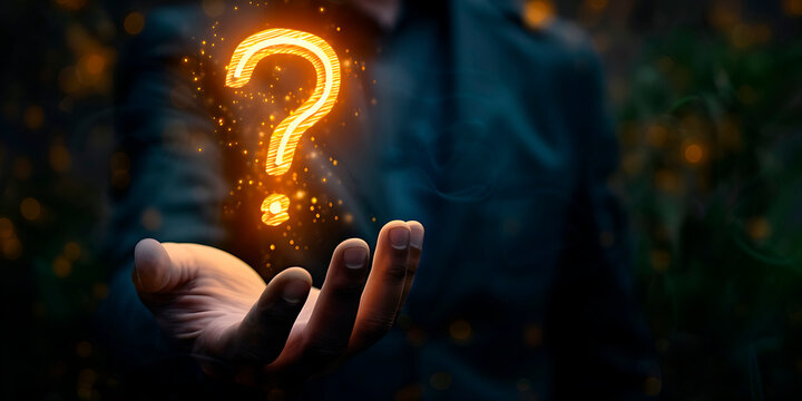 A hand holding a glowing question mark. Concept of curiosity and wonder, as the question mark is lit up and he is floating in the air
