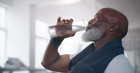 Senior, gym and black man drinking water after workout with bottle for hydration, thirst or wellness. Health, tired and elderly person with towel for cardio training, exercise or rest for nutrition - Powered by Adobe