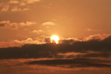 Close up view of sun hidden behind clouds photography