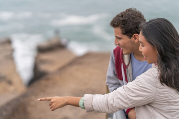 Couple enjoying contemplating the sea views from viewpoint