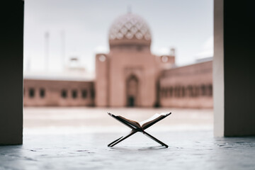 Islamic concept - The Holy Al Quran at beautiful mosque with written Arabic calligraphy meaning of...