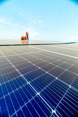 engineer man inspects construction of solar cell panel or photovoltaic cell by electronic device....