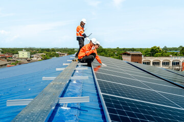 engineer man inspects construction of solar cell panel or photovoltaic cell by electronic device....
