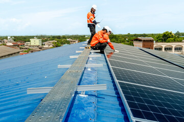 engineer man inspects construction of solar cell panel or photovoltaic cell by electronic device....