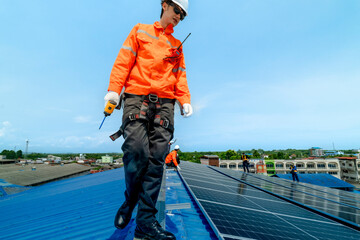 engineer man inspects construction of solar cell panel or photovoltaic cell by electronic device....