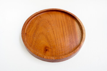 Round wooden plate isolated on white background