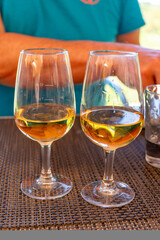 Tasting of Bordeaux white wine in Sauternes, left bank of Gironde Estuary, France. Glasses of white sweet French wine served in restaurant