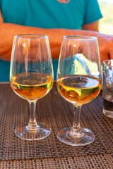 Tasting of Bordeaux white wine in Sauternes, left bank of Gironde Estuary, France. Glasses of white sweet French wine served in restaurant