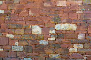 Brick background in Collonges-la-Rouge village, one of the most beautiful villages in France with houses made from red stones, tourists destination in Dordogne