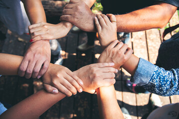 Diverse multiethnic Partners hands together teamwork group of multiracial people meeting join hands togetherness. Diversity people hands join empower partnership teams connection volunteer community