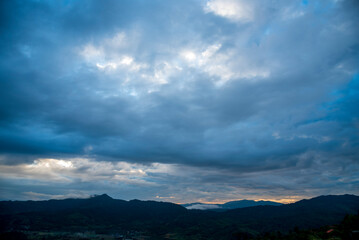 Fototapeta premium Scenic view dramatic beautiful sunset sky. Natural Sunset Sunrise on meadow silhouette shadow dark land. Vibrant dramatic sky on sunset, dawn, sunrise in Countryside. Landscape Colorful Sky At Sunset