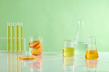 Creative template for designing with several lab equipments placed on white countertop, against the green background. Product displaying and advertising space