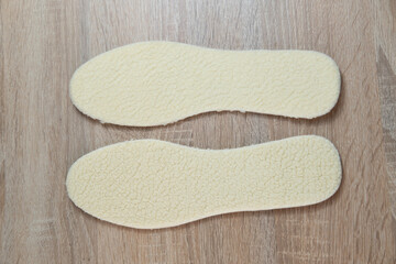 Warm and cozy shoe insoles crafted from natural white sheepskin for ultimate comfort in cold weather