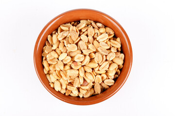 roasted peeled peanuts in ceramic bowl isolated on white background