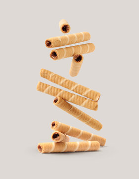 Creative layout made of wafer roll on the gray background. Food concept. Macro concept.