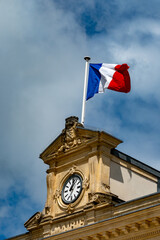Blue red white french flag on roof of ciry hall in France
