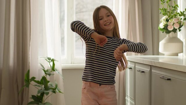 Caucasian little girl dancer active pastime child daughter happy fun cheerful female smiling home enjoy excitement freedom energetic playful joy positive music childhood flexibility happiness pleased