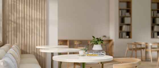 The interior design of a contemporary minimalist coffee shop indoor seating area.