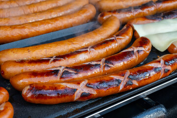 German street food on Portobello road Saturday food market, London, Uk, many BBQ grilled sausages ready to eat in outdoor café