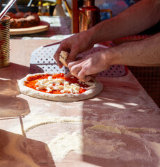 Making of fresh Italian pizza, street food, Portobello road food market on Saturday, London, UK
