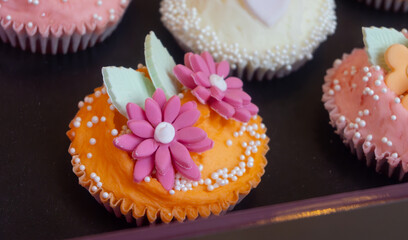 Colorful marzipan almongs cakes with decorative marzipan flowers