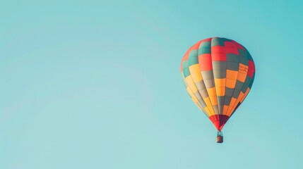 Naklejka premium Colorful hot air balloon floating in the clear blue sky, representing freedom, adventure, and travel on a sunny day.
