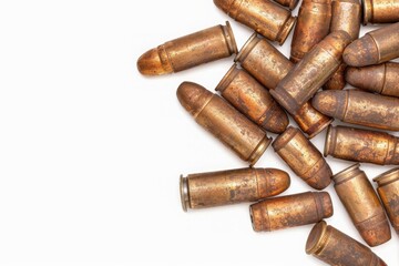 Close-up of a pile of rusty bullets on a white background, showing aging and corrosion over time.