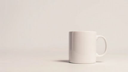 Obraz premium Minimalistic white mug on a plain background, perfect for showcasing simplicity and elegance in kitchenware or lifestyle designs.
