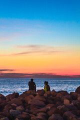 Couple sitting in front of the sea contemplating the sunset in Puerto Vallarta Jalisco
