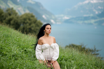 Farm girl. Fresh milk. Sexy model with milk on nature. Sensual woman hold bottle of milk near farm grass. Alpine country cow girl, milking. Woman with milk in Switzerland Alps. Milky Swiss Alps.