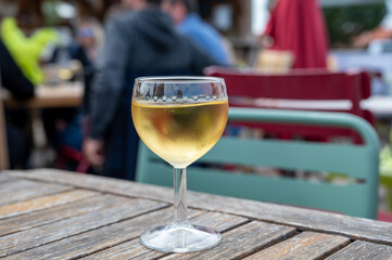 Tasting of Bordeaux white wine, right bank of Gironde Estuary, France. Glasses of white sweet French wine served in outdoor restaurant on oysters farm in Gujan-Mestras, Arcachon bay
