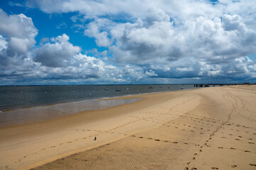 Walking on beach promenade in Arcachon, vacation destination town on Atlantic coast with beatiful parks, villas, streets and sandy beach, France