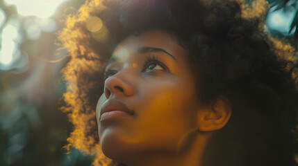 Woman with Natural Hair in Sunlight, Looking up with Determined look of Strength