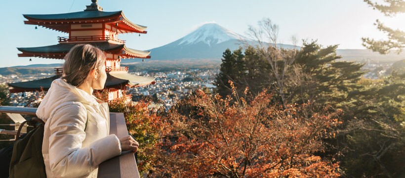 Woman tourist with mount Fuji at Chureito Pagoda in Autumn season, Traveler travel Arakurayama Sengen Park, Yamanashi, Japan. Landmark for tourist attraction. Japan Travel, Destination and Vacation