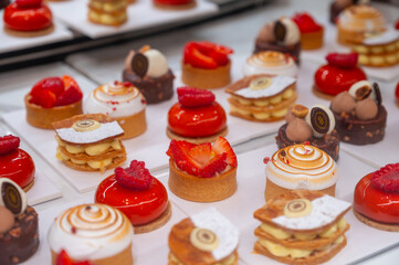 Various sweet cakes meringue, red fruits and berries framboise tartlets with cream