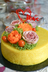 Pulut kuning, glutinous rice cooked with turmeric powder, salt and coconut milk.  Decoration from raddish and carrot for special occassion like birthday, wedding or hari raya (eid).