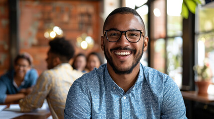 A Latino mans warm smile as he acknowledges a colleagues contribution
