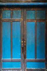 Front view of old blue wooden door.