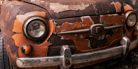 Close up front view old rusty car in a panoramic view. Classic retro auto.
