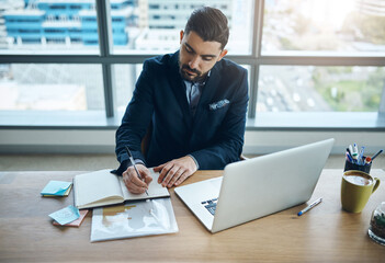 Computer, notebook and business man in office for financial analysis, company review and data analytics. Corporate, consultant and person writing notes on laptop for research, website and report