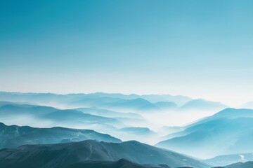 A breathtaking view of a distant mountain range with layered peaks under a clear sky, showcasing natural beauty and serene landscapes