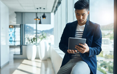 Office, reading and Asian man at window with tablet for email, report or web review for online business consultant. Relax, research and businessman on digital app for networking, planning or schedule