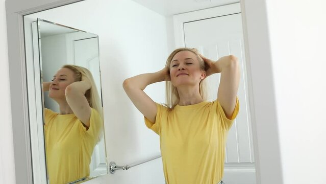 37 yo Caucasian Woman Massages Her Head Skin, Hair in Bathroom. Blond White Female Doing Head Massage to Purify and Sooth her Hair. Cosmetics Product. Horizontal Video. Haircare. Slow Motion