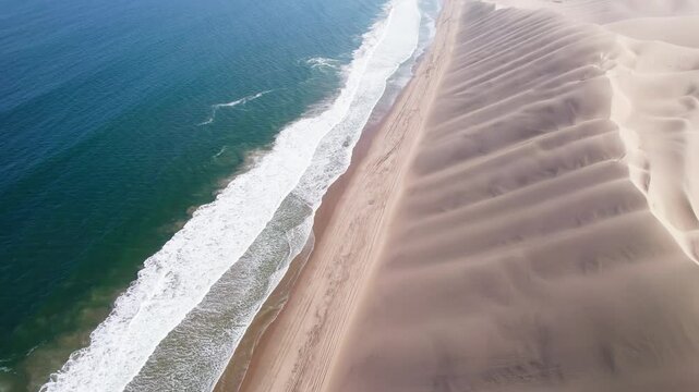 Ocean and dunes, morning, sunrise landscape.. Walvis Bay Namibia Africa. Aerial footage, 4k Dlog to Rec.709