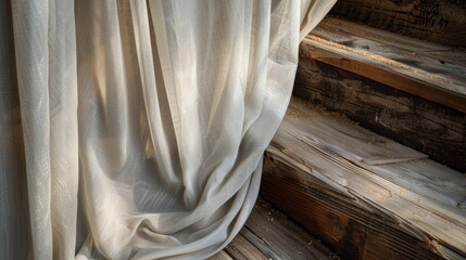 The fabric cascades down a set of stairs creating a beautiful contrast against the rustic wooden boards.